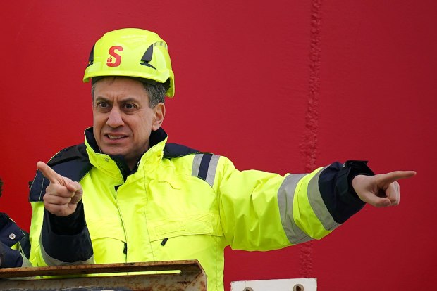 a man wearing a yellow hard hat with the letter s on it