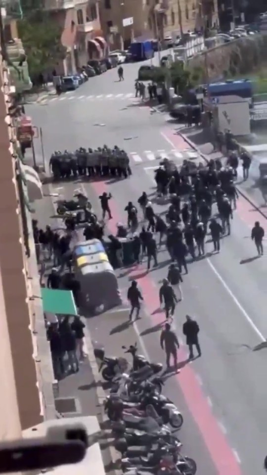 a large group of people are walking down a street