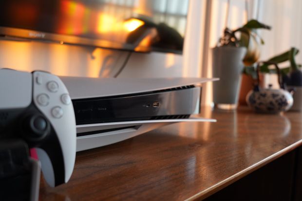 a sony tv is behind a ps5 console