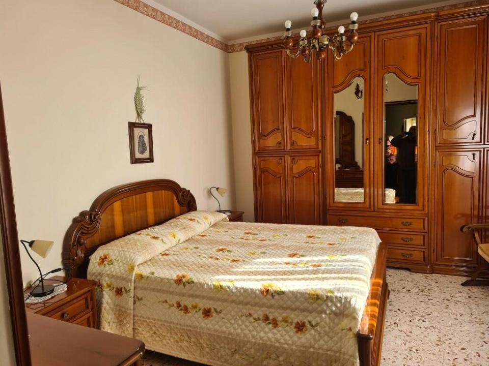 a bedroom with a bed and a large wardrobe