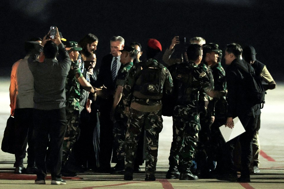 Mehrtens, (centre left), is greeted by New Zealand Ambassador to Indonesia Kevin Burnett at Halim Perdanakusuma Air Base on Saturday