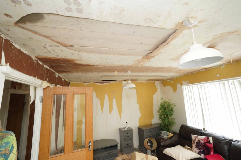 Parts of the lounge ceiling has already collapsed in and the wallpaper is torn away