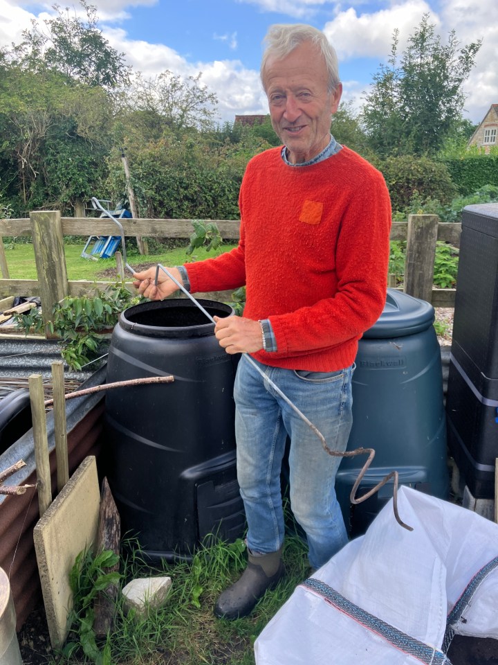 Charles Dowding in his Somerset garden with his dalek compost bin and an aerator