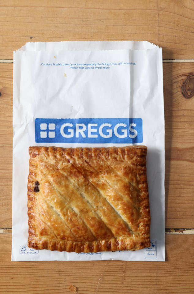 a pastry in a bag that says greggs on it