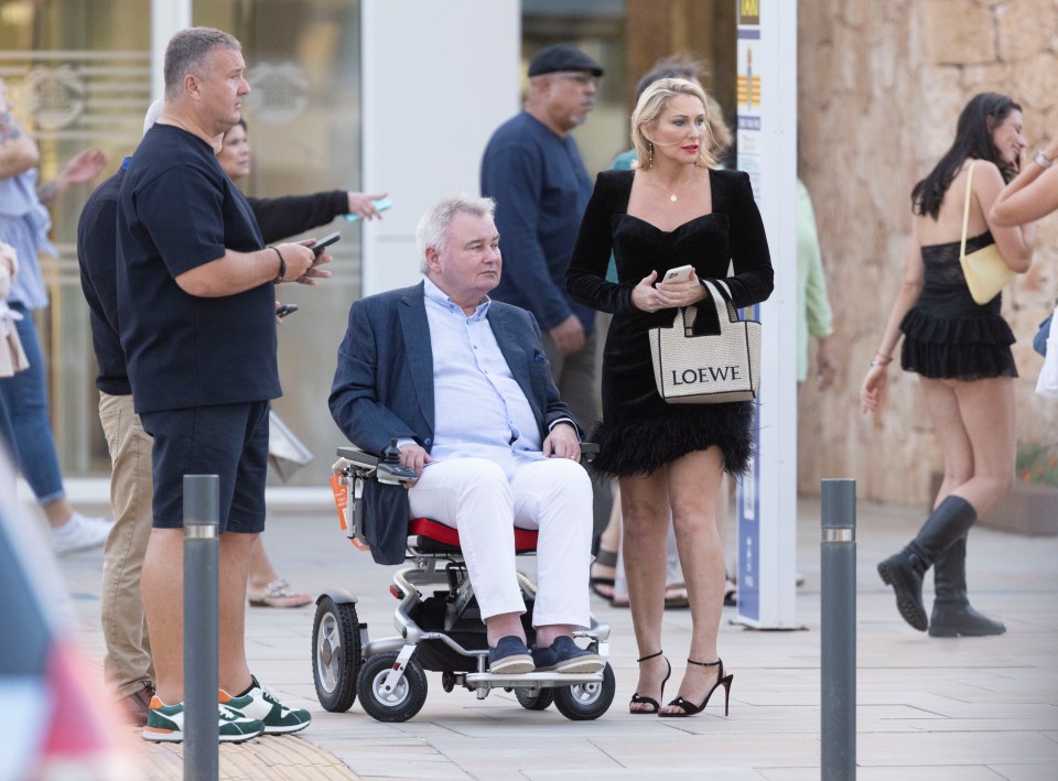 a man in a wheelchair has a loewe bag on his shoulder