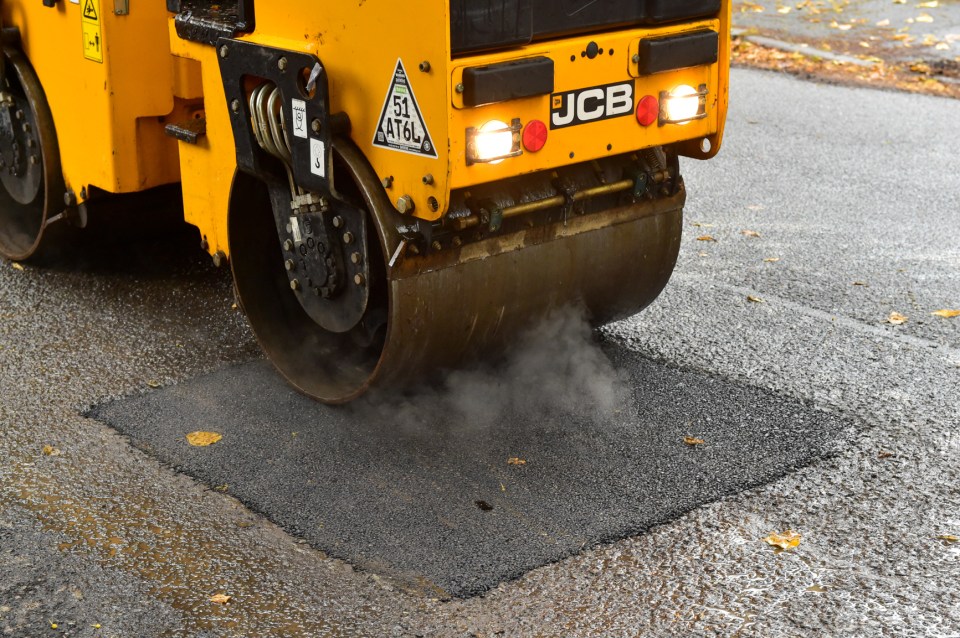 Steamroller levels road surface