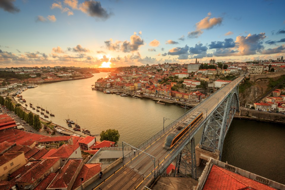 a train is going over a bridge over a river