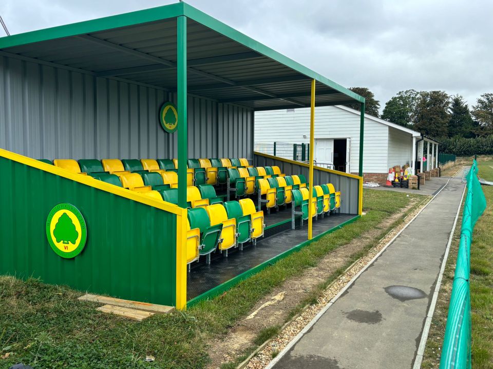 a stadium with green and yellow seats and a sign that says ' a ' on it