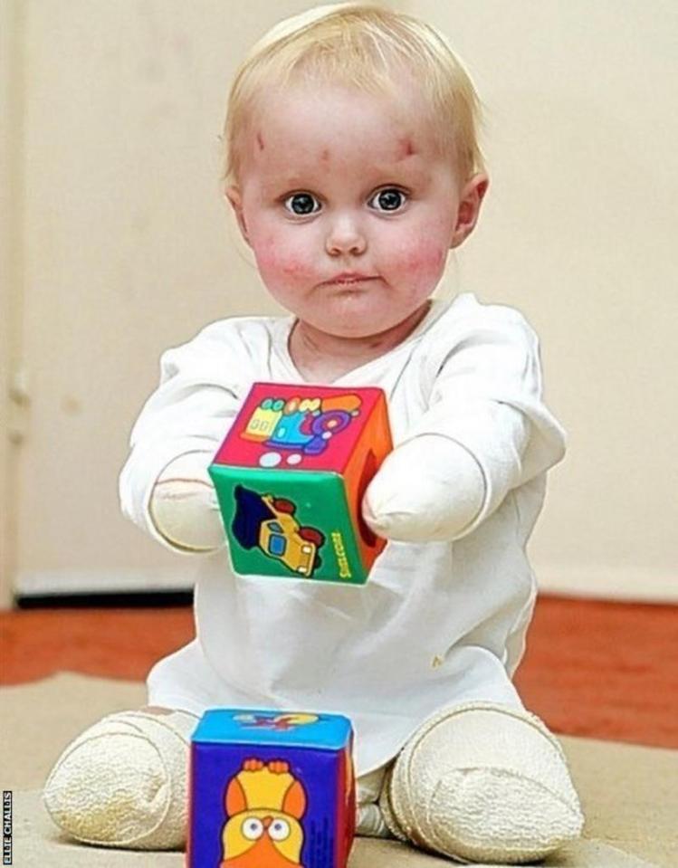 a baby is playing with a sesame street block