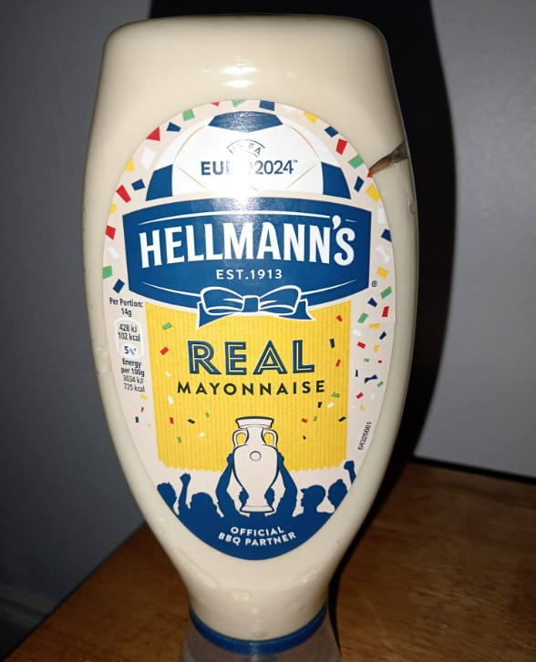 a bottle of hellmann 's real mayonnaise on a table