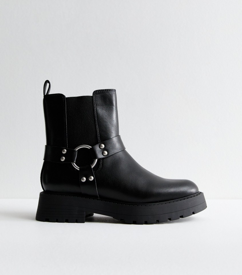 a pair of black boots with a buckle around the ankle