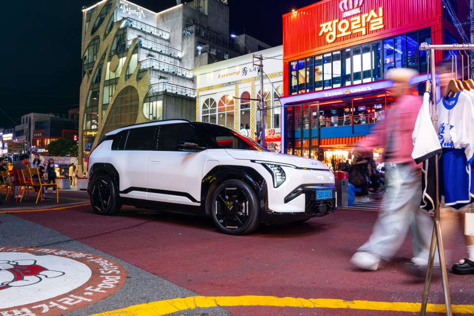 a white car is parked in front of a building that says luxury