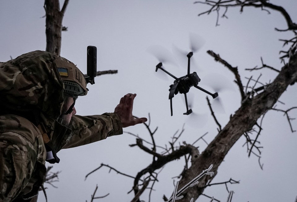 A Ukrainian soldier launches a kamikaze FPV drone on the front line