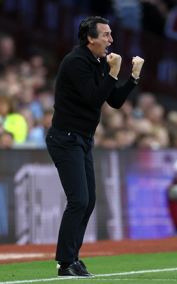 a man on a soccer field with his fist in the air