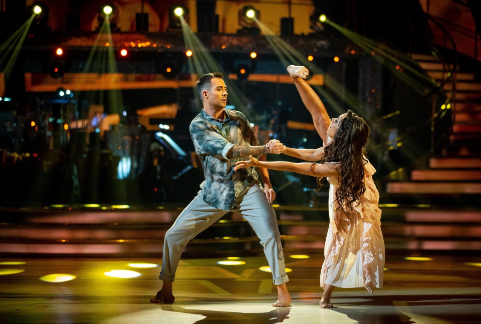 a man and a woman are dancing on a stage