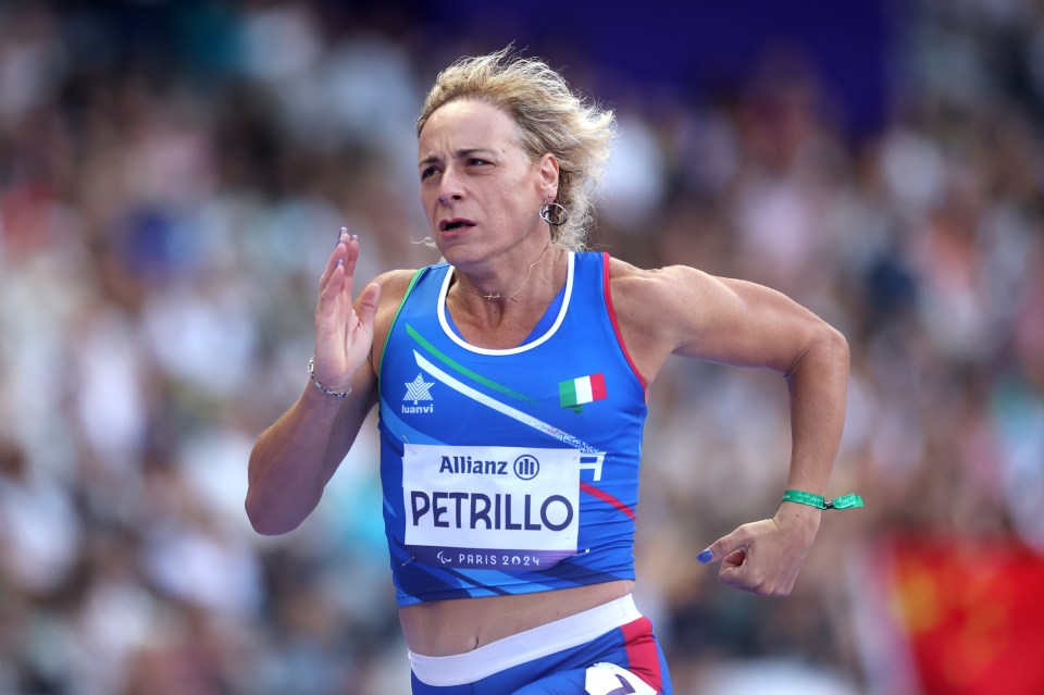 a woman wearing a blue tank top that says petrillo on it