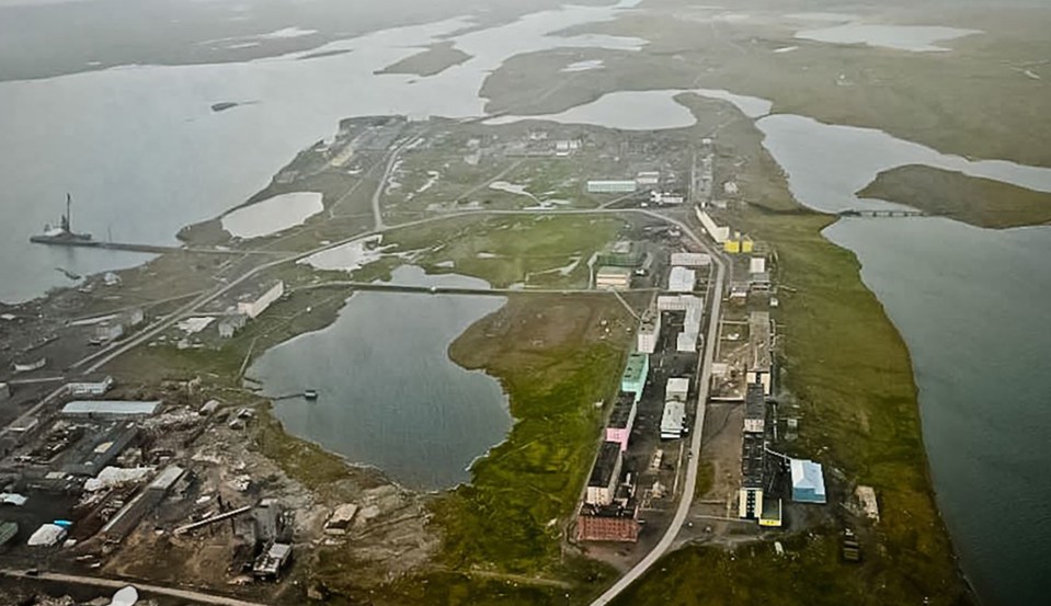 an aerial view of a small town in the middle of a large body of water