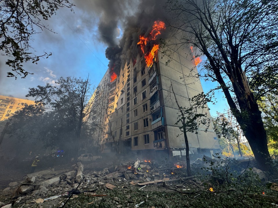 A view shows a burning apartment building hit by a Russian air strike