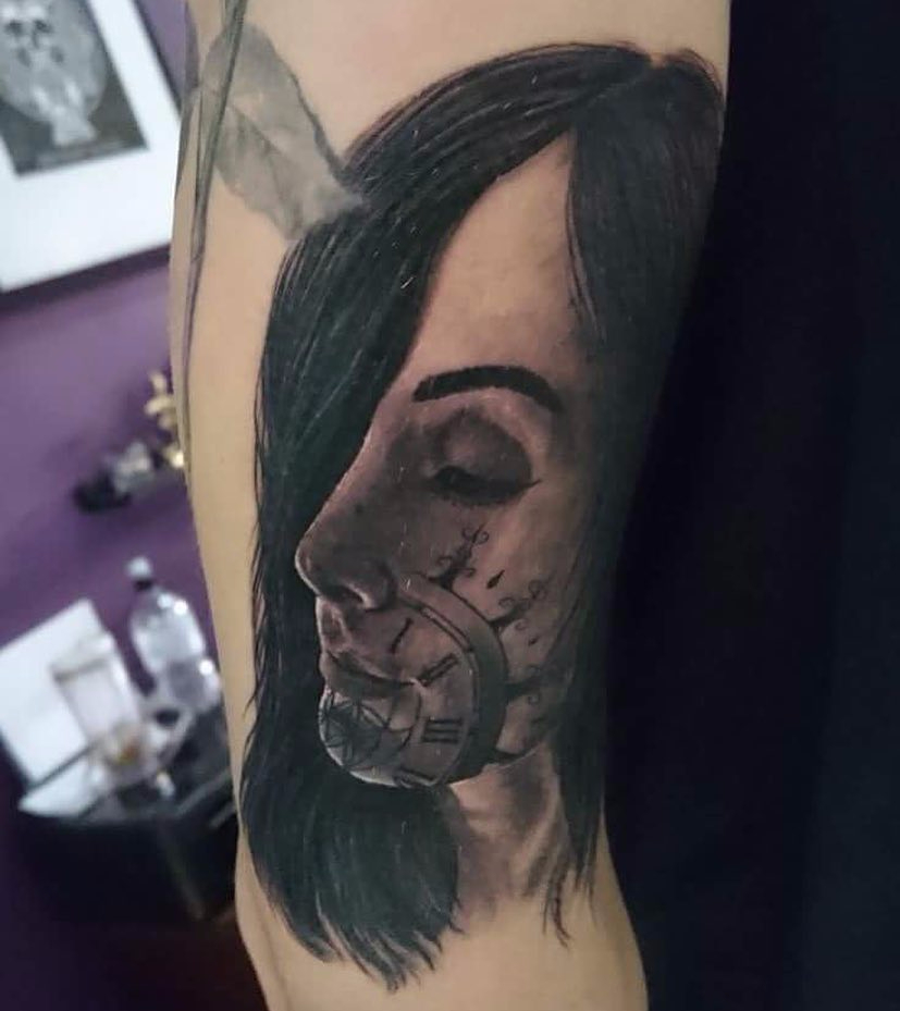 a tattoo of a woman with a clock on her face