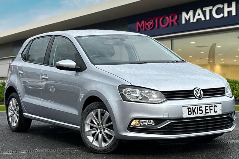 a silver volkswagen polo is parked in front of a motor match dealership