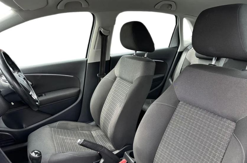 the front seats of a car with the door open