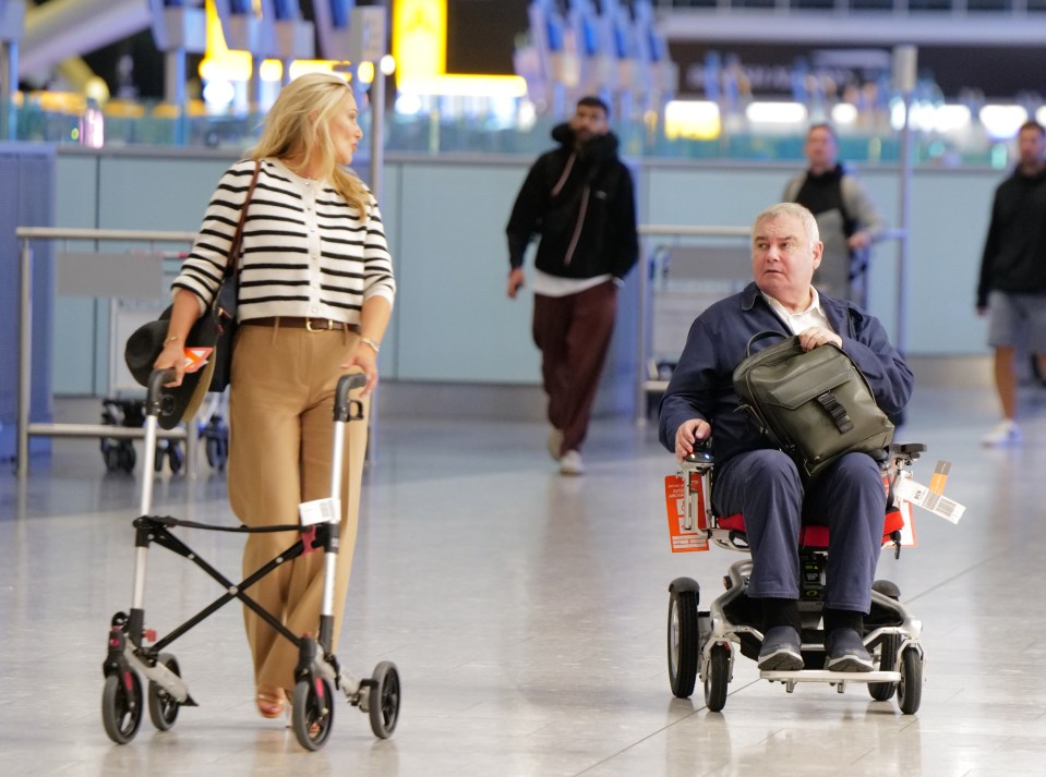 a man in a wheelchair is being pushed by a woman with a walker