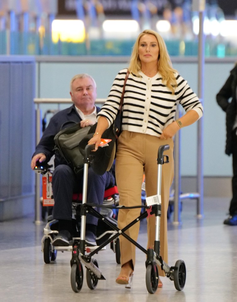 a woman pushes a man in a wheelchair with a walker