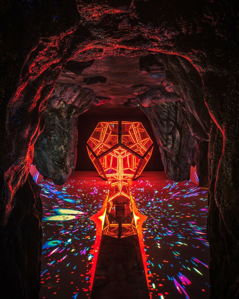 a dark cave with a glowing object in the middle