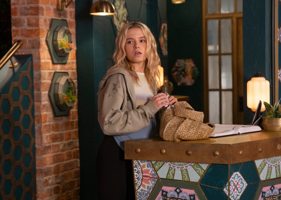 a woman standing behind a counter with a book on it