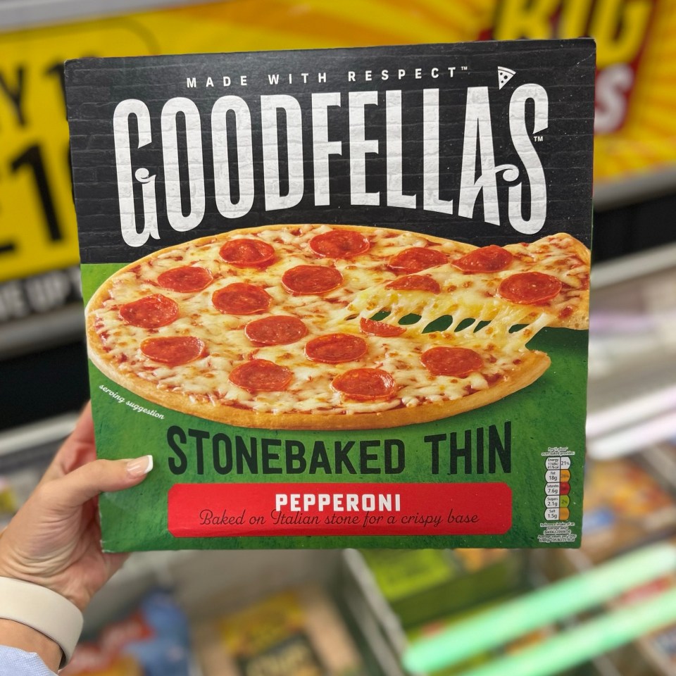 a person is holding a box of goodfellas stonebaked thin pepperoni pizza