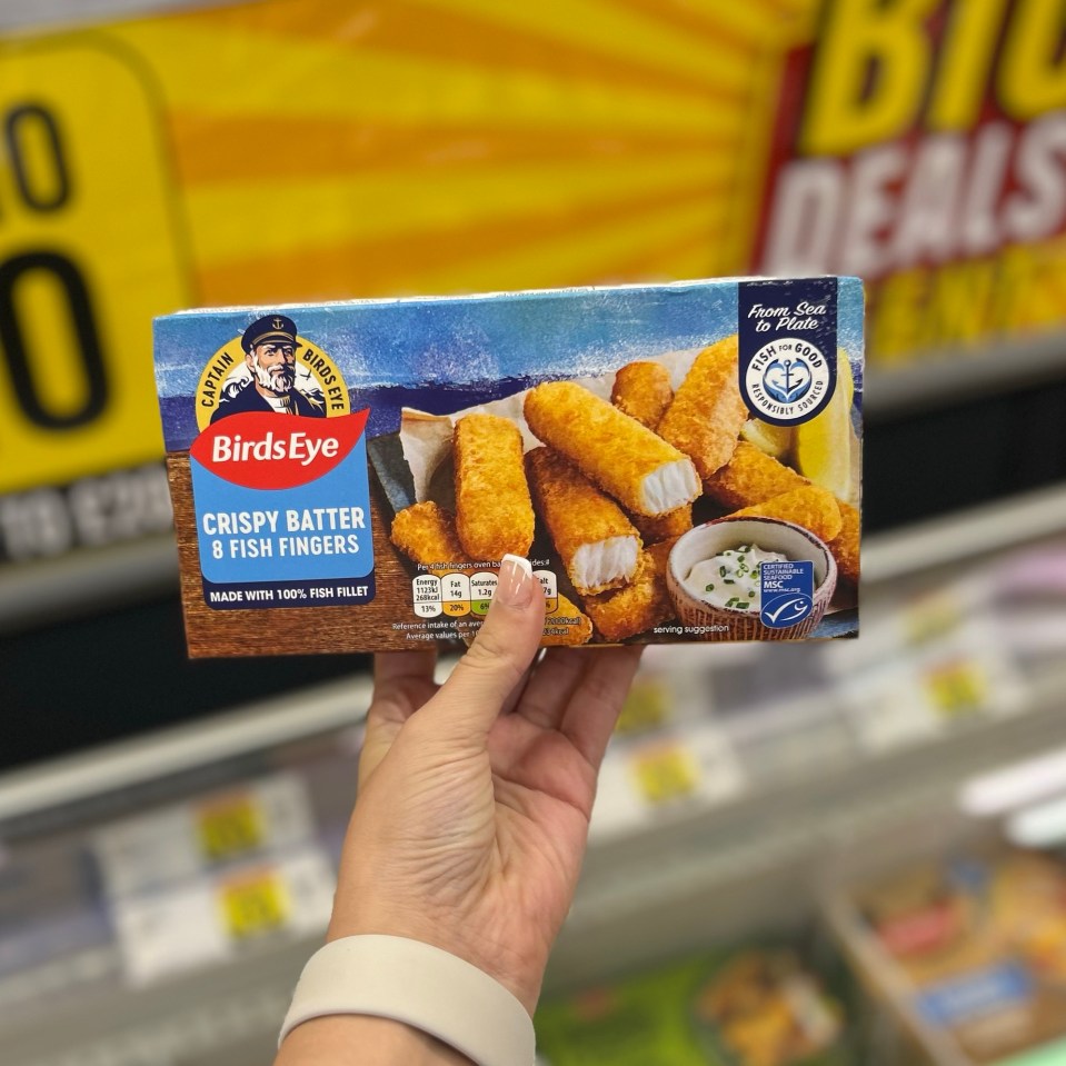 a person is holding a box of birds eye crispy batter fish fingers