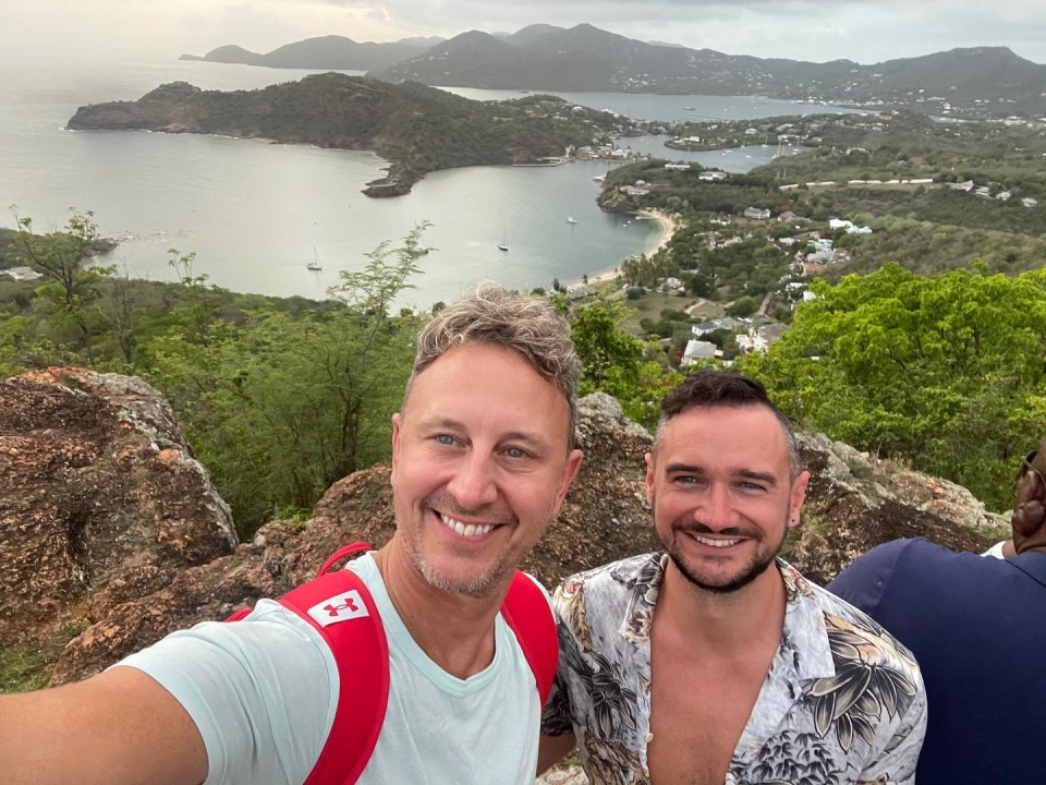 two men are posing for a picture with a canadian flag on their backpack