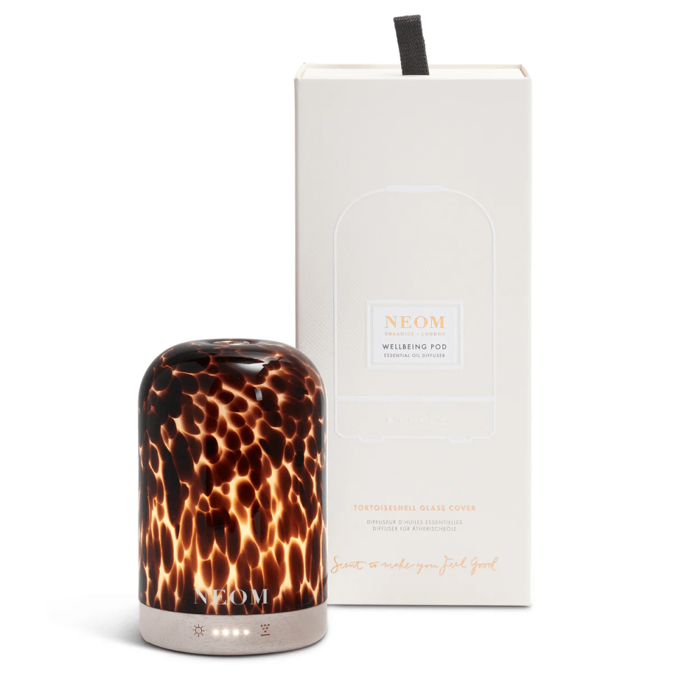 a leopard print diffuser next to a box that says neom