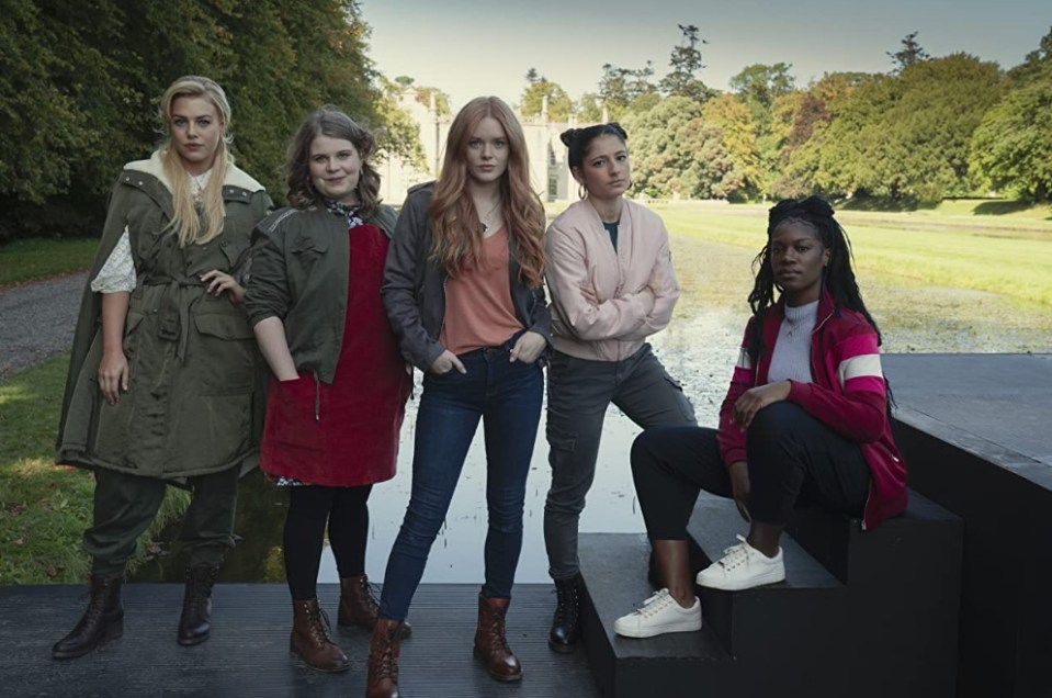 a group of women standing next to each other with their arms crossed