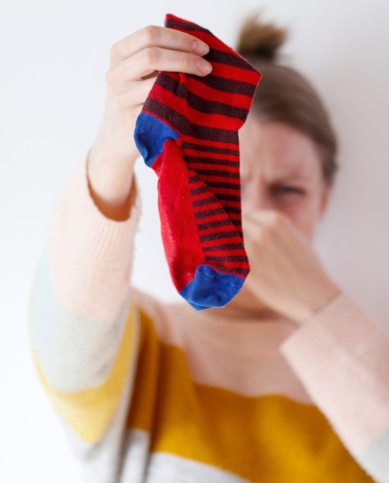 a woman holds up a pair of striped socks