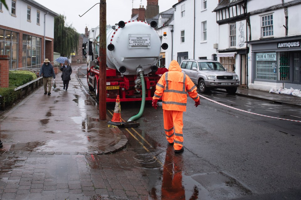 Workers drain Brookend Street in Ross-on-Wye in Herefordshire on Sunday morning