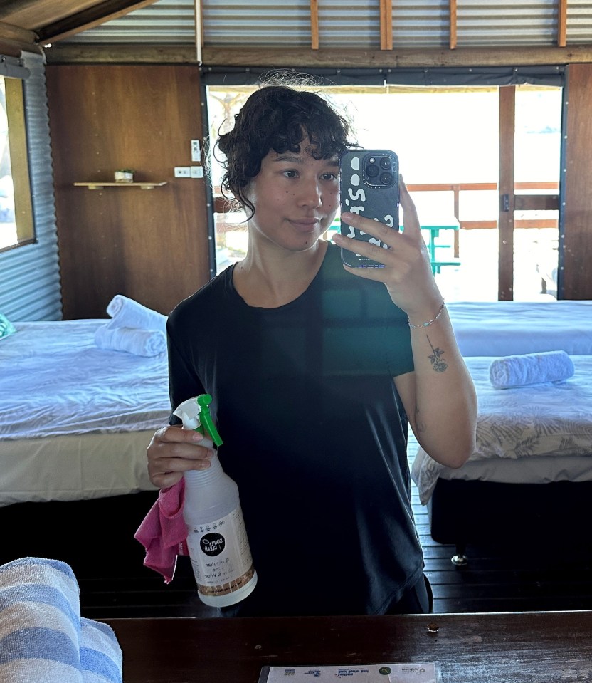 a woman taking a selfie in front of a mirror while holding a spray bottle that says dawn