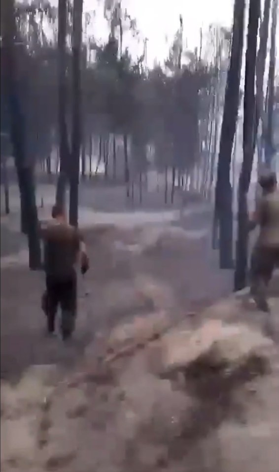 Russian soldiers can be seen walking around the tank graveyard