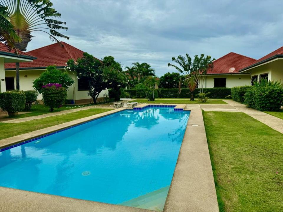 a large swimming pool surrounded by houses and trees