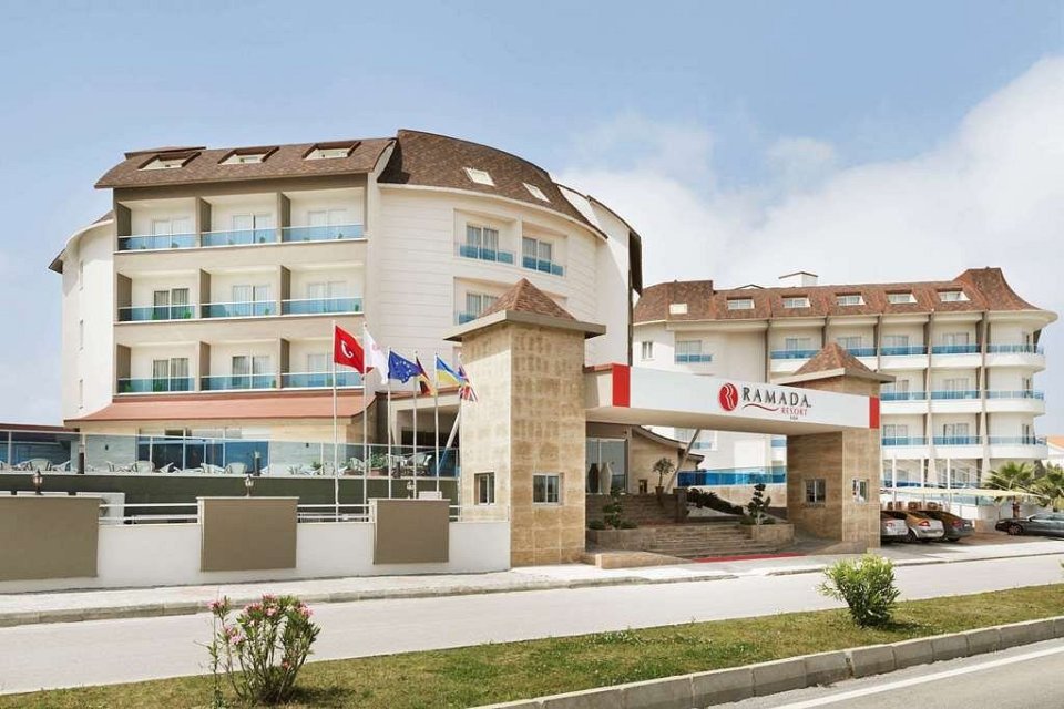 a ramada hotel with a lot of windows and balconies