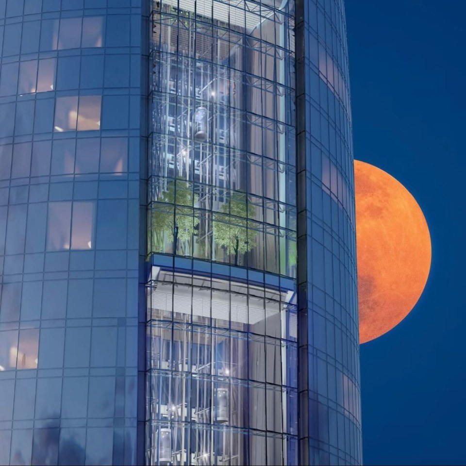 a tall building with a full moon in the background