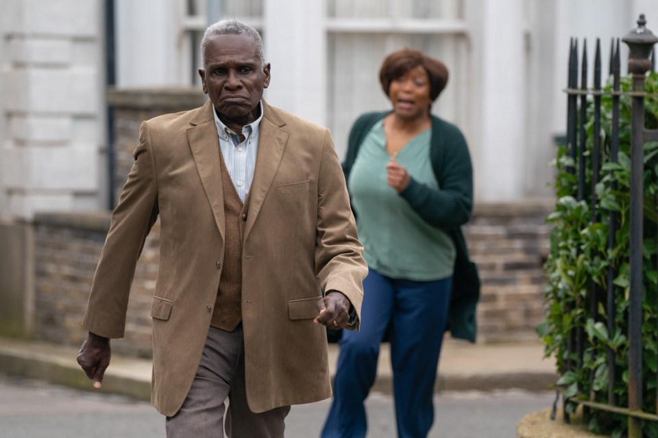 a man and a woman are walking down a street