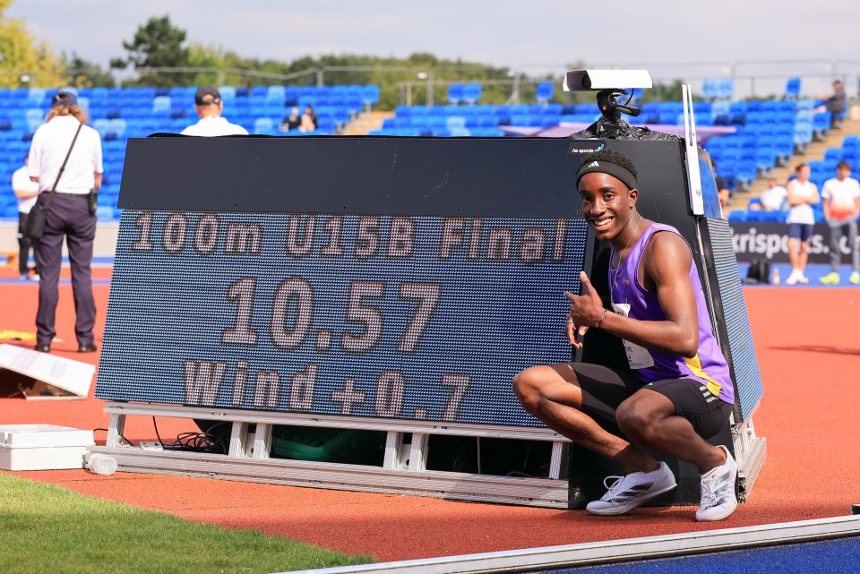 a man is kneeling in front of a sign that says 100m u15b final