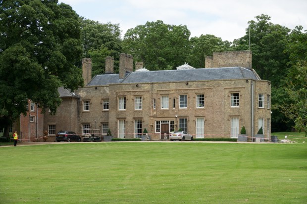 a large brick building with a white car parked in front of it