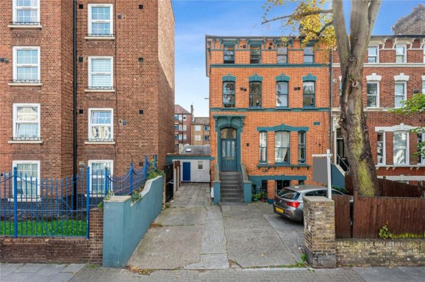 a brick building with a car parked in front of it