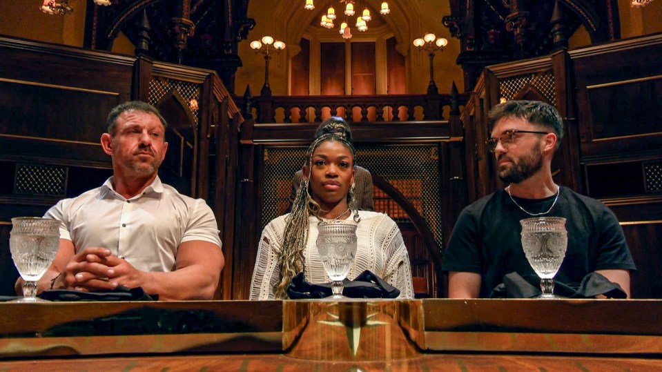 three people sit at a table with wine glasses on it