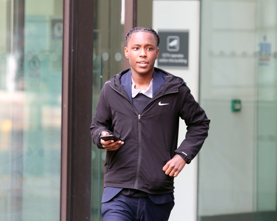 a man wearing a black nike jacket is running