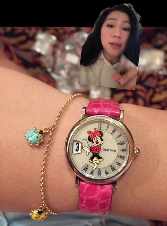 a woman wearing a minnie mouse watch on her wrist