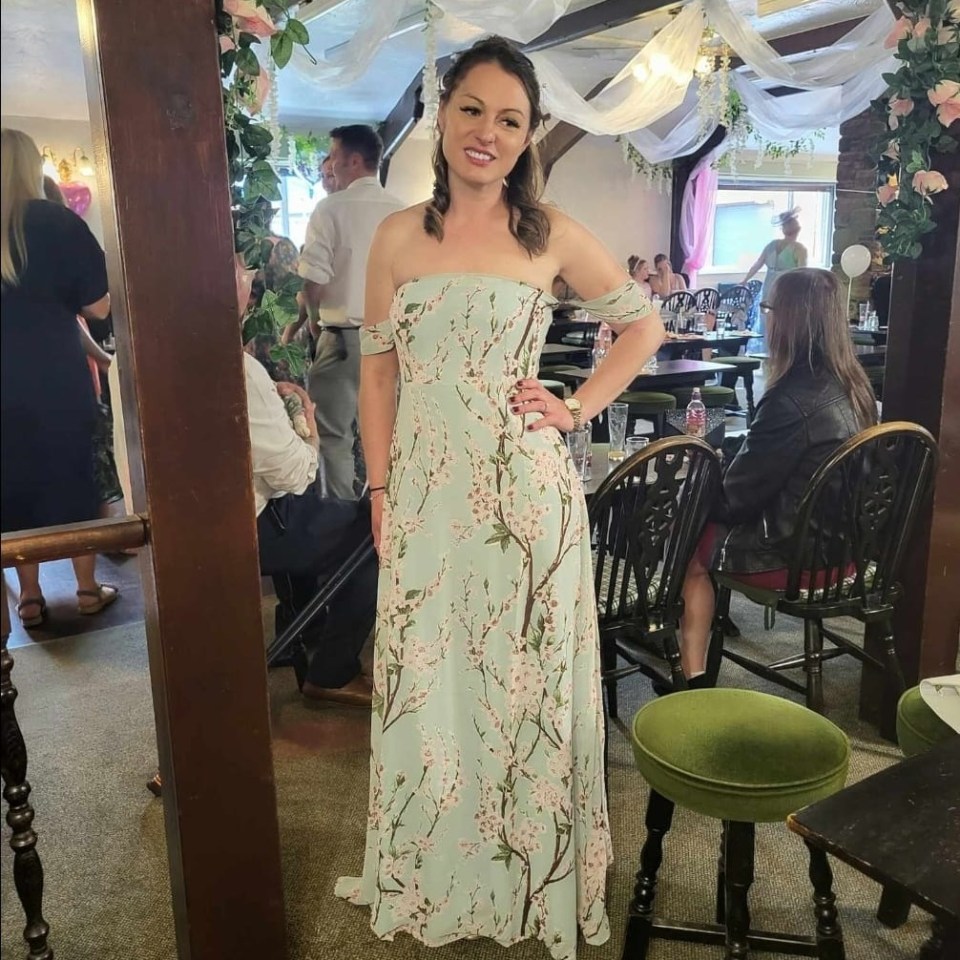 a woman in a floral dress is standing in a room