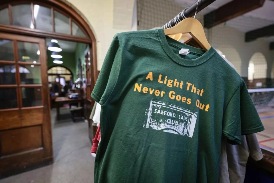 a green t-shirt that says a light that never goes out